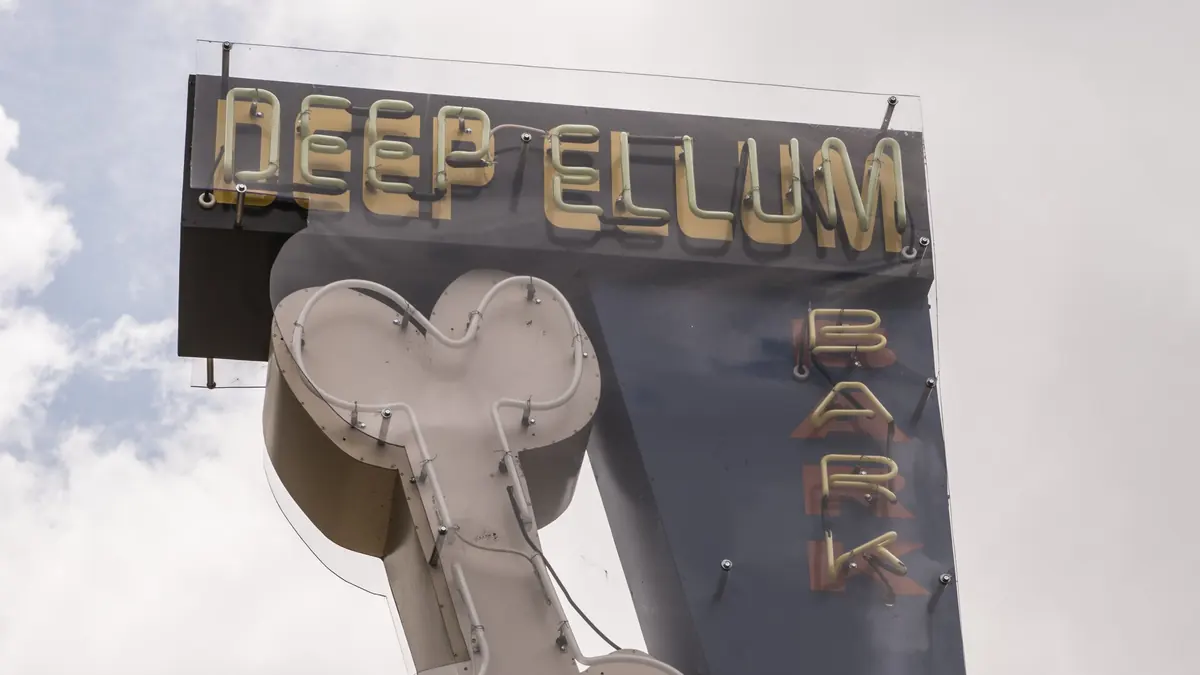 Neon dog-bone sign at the Deep Ellum bark park in Dallas